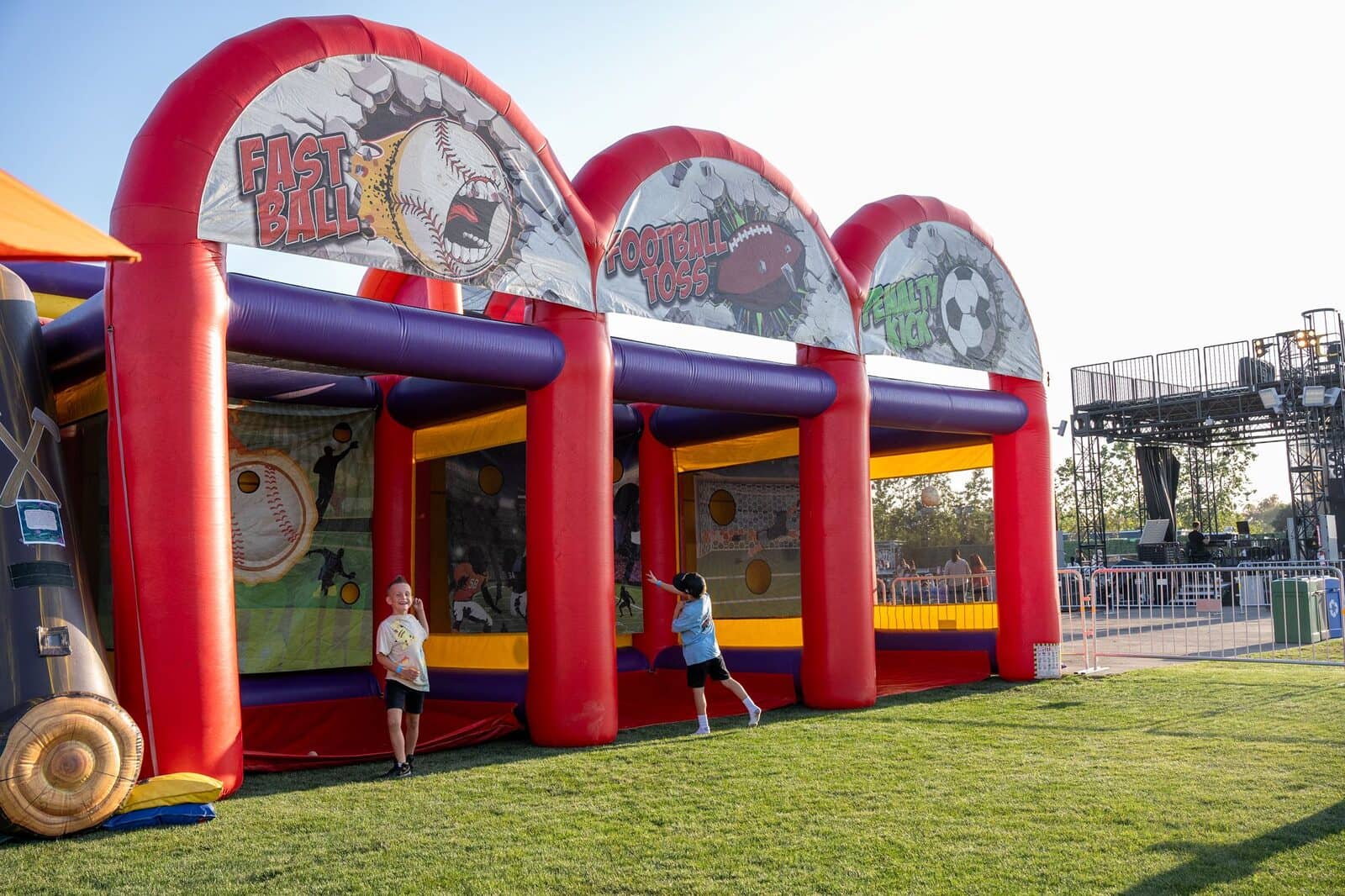 The Triple Threat inflatable's sports lanes in action at the 2025 festival